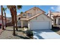 Two-story house with tile roof, attached garage, and desert landscaping at 3275 Canyon Terrace Dr, Laughlin, NV 89029