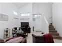 Spacious living room with high ceilings and a staircase at 521 Wing Gull Ct, North Las Vegas, NV 89032