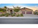 Single-story home with a three-car garage and landscaped front yard at 7083 Arabian Ridge St, Las Vegas, NV 89131