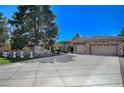 Beautiful stone house with 3-car garage and landscaped front yard at 2945 S Monte Cristo Way, Las Vegas, NV 89117