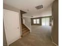 Bright entryway with staircase and view into spacious living room at 2604 Courlan Dr, North Las Vegas, NV 89084