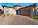 Modern house exterior with brick driveway at 6817 Steel Mist St, Las Vegas, NV 89148