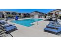 Community pool with lounge chairs and cabanas at 7334 N Decatur Blvd # 6, North Las Vegas, NV 89084