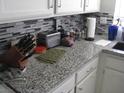 Kitchen with granite countertops and white cabinets at 322 Oliveiro Ct, Henderson, NV 89014