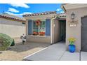 Inviting front entry with decorative planters and blue shutters at 3741 Garnet Heights Ave, North Las Vegas, NV 89081