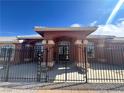 Home exterior with welcoming entryway and wrought iron gate at 3301 S Rainbow Ave, Pahrump, NV 89048