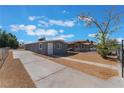 Updated gray house, featuring a private driveway and neat landscaping at 1225 Lawry Ave, Las Vegas, NV 89106