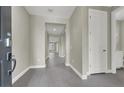 Bright hallway with gray tile floors and access to rooms at 2110 Millergrove Ave, North Las Vegas, NV 89086