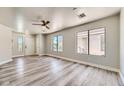 Bright living room with neutral walls, wood-look floors, and ceiling fan at 1038 Silver Creek Ave, Las Vegas, NV 89183