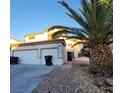 Two-story house with a three-car garage and desert landscaping at 4116 Mattray St, North Las Vegas, NV 89032