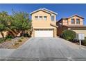 Two-story house with attached garage and landscaping at 9570 Wenmarie Ct, Las Vegas, NV 89148