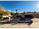 Brick ranch home with a two-car garage and landscaped yard at 2863 Marathon Dr, Henderson, NV 89074