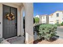 Gray front door accented with a fall-themed wreath at 6271 Sunset Spring Ave, Las Vegas, NV 89122