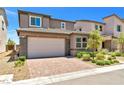 Two-story house with attached garage and landscaped front yard at 9332 Lunar Effect St, Las Vegas, NV 89143