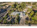 Aerial view of single story home with large yard, mature trees, and detached garage at 5881 S Sandhill Rd, Las Vegas, NV 89120