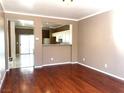 Living room with hardwood floors and an open view to the kitchen at 7451 Grizzly Giant St, Las Vegas, NV 89139