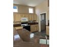 Kitchen features granite countertops and wood cabinets at 10717 Grand Cypress Ave, Las Vegas, NV 89134