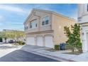 Tan three-story house with three-car garage at 8687 Roping Rodeo Ave # 101, Las Vegas, NV 89178