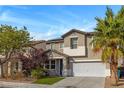 Two-story house with a two-car garage and landscaping at 5008 Lonesome Spur Ave, Las Vegas, NV 89131