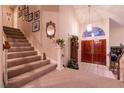 Elegant staircase with wall decor and wood railings at 2317 Harbor Cliff Dr, Las Vegas, NV 89128