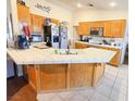 Kitchen with wood cabinets, tile countertops, and island at 3261 Winery Rd, Pahrump, NV 89048