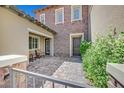 Inviting courtyard entryway with seating area and stone pavers at 4093 San Franchesca Ct, Las Vegas, NV 89141