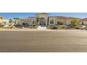 Home exterior with tile roof, arched entryway, and desert landscaping at 1720 Oval Cir, Las Vegas, NV 89117