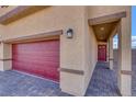 Red garage door and walkway leading to the front door at 7741 Markarian St, North Las Vegas, NV 89084