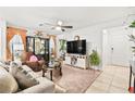 Living room with TV, couch, and access to the kitchen at 2461 Creeping Rosemary Ct, Las Vegas, NV 89115