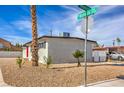 Side view of the house showing landscaping and street view at 5100 Kansas Ave, Las Vegas, NV 89107