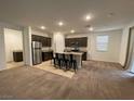 Modern kitchen with dark cabinets, stainless steel appliances, and an island at 5264 Steptoe St, Las Vegas, NV 89122