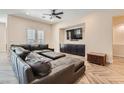 Spacious living room with a large sectional sofa and herringbone floors at 8035 Brown Clay Ave, Las Vegas, NV 89113