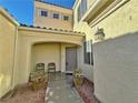 Inviting entryway with two chairs and potted plants at 8621 Echo Grande Dr, Las Vegas, NV 89131