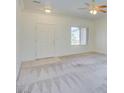 Bright living room featuring neutral walls, carpeting, and a ceiling fan at 1952 High Mesa Dr, Henderson, NV 89012