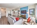 Bright living room featuring hardwood floors and a stylish blue accent wall at 9929 Cameron St, Las Vegas, NV 89141