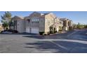 Tan two-story townhome with attached garage at 9975 Peace Way # 1058, Las Vegas, NV 89147