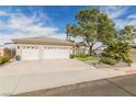 Single-story house with three-car garage and manicured lawn at 1095 Endora Way, Boulder City, NV 89005