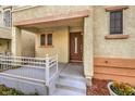 Inviting front entrance with covered porch and small railing at 9105 Parapet Ave, Las Vegas, NV 89149