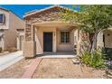 Two-story house with stone accents and attached garage at 1228 Oak Village Ave, Las Vegas, NV 89183