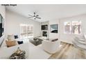 Virtually staged living room with fireplace and sliding glass doors at 1941 Toscanini Way, North Las Vegas, NV 89032