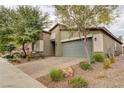 Single-story home with gray garage door, landscaping, and brick driveway at 2156 Del Aqua Ave, Henderson, NV 89002