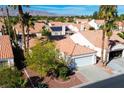 Aerial view of a community of houses with tile roofs and palm trees at 5513 Desert Valley Dr, Las Vegas, NV 89149