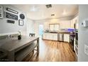 Kitchen with white cabinets, stainless steel appliances, and light wood floors at 6824 Mesita Ave, Las Vegas, NV 89122