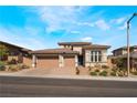 Two-story home with a two car garage and desert landscaping at 12446 Brass Ridge Dr, Las Vegas, NV 89138