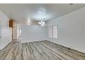 Bright dining room features wood-look floors and a chandelier at 6214 Osaka Pearl St, North Las Vegas, NV 89031