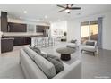 Inviting living area opens to the kitchen and features contemporary furniture and access to the backyard at 10972 Chipotle Ave, Las Vegas, NV 89166