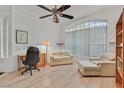 Home office with hardwood floors, comfortable seating, and a large window at 8557 Summer Vista Ave, Las Vegas, NV 89145