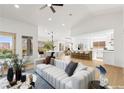 Bright and airy living room with open floor plan to kitchen and dining area at 2820 Lotus Hill Dr, Las Vegas, NV 89134