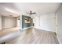 Open concept living room and dining area with light gray walls and wood-look flooring at 3411 Sunfish Dr # B, Henderson, NV 89014