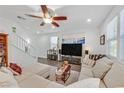 Spacious living room with L-shaped sectional sofa, large TV, and hardwood floors at 10636 Lomaland Ave, Las Vegas, NV 89166